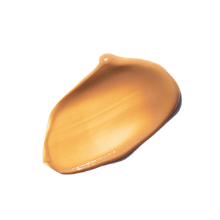 Creamy caramel liquid foundation swatch on white background, offers smooth application and natural finish.